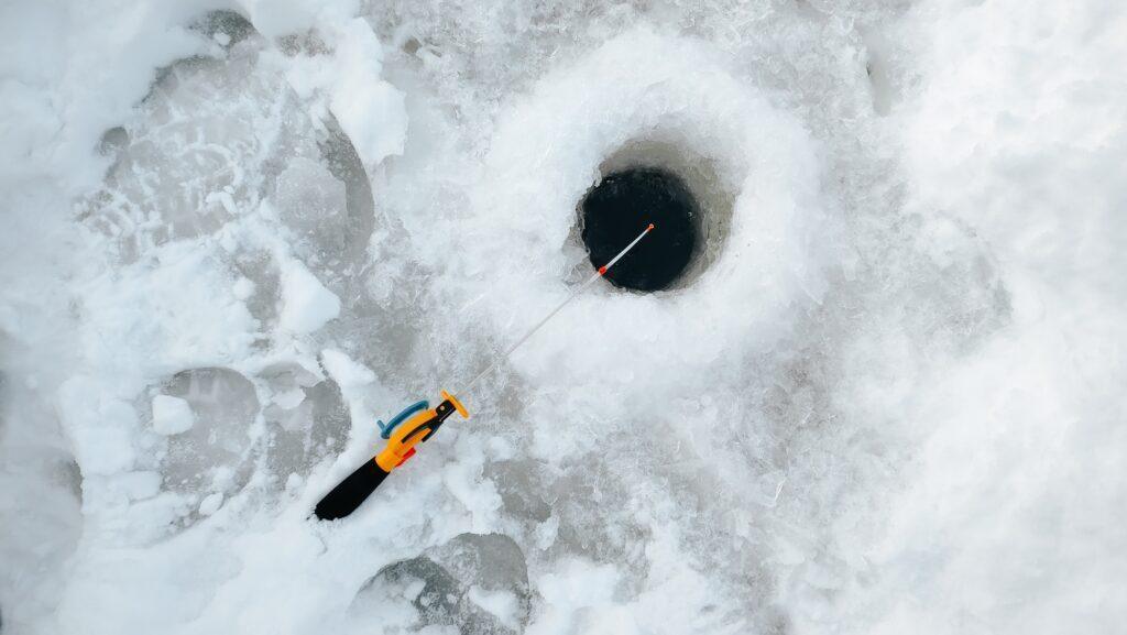 yellow-small-fishing-rod-and-a-hole-in-the-ice-winter-fishing-1024x577